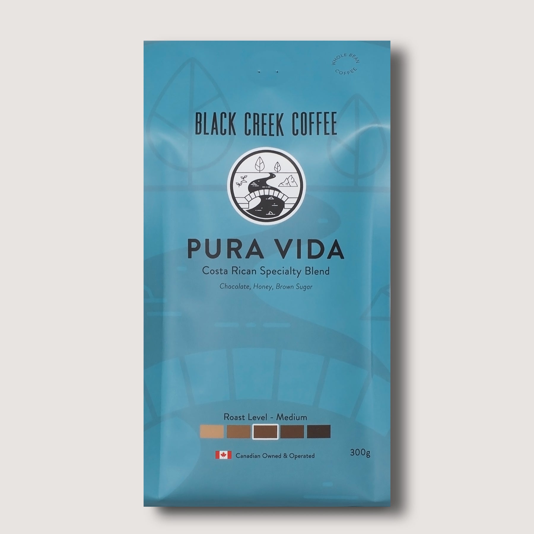 Blue coffee package with 'Black Creek Coffee' branding on a light gray background